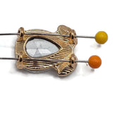 Clear crystal rhinestone slider beads set in polished bright gold plated metal for bracelets and jewelry making. Large faceted teardrop rhinestones create brilliant reflective sparkle while two smaller crystals add dimensional detail. Hidden back loops provide two stringing points approximately 9 mm apart for double-strand bracelets, multi-strand necklaces, bead weaving, wedding jewelry, statement pieces, and sophisticated DIY jewelry designs.