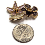 Gold flower slider beads with multicolor enamel details for handmade jewelry and bracelet making. Each decorative 2 hole focal bead features layered blush pink and plum flowers beside a creamy ivory leaf, all outlined with polished bright gold metal. Measuring approximately 26 mm long and 17 mm wide, these botanical jewelry components are beautiful for bead weaving, double-strand bracelets, necklaces, and floral designs.