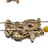Dimensional floral focal beads in bright gold plated metal with pink, plum, and ivory enamel botanical details. These 2 hole slider beads measure approximately 26 mm by 17 mm and feature two different flower designs accented by a sculpted leaf. Decorative jewelry-making components for double-strand bracelets, multi-strand necklaces, bead weaving, floral jewelry, romantic accessories, spring designs, and creative jewelry making at home.