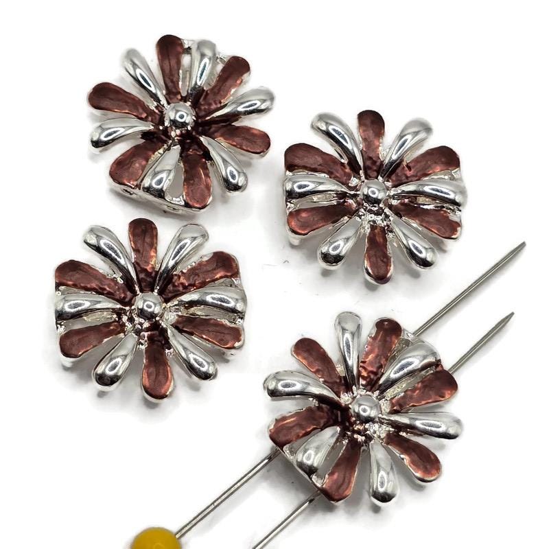Purple enamel floral 2 hole slider beads featuring alternating polished bright silver and rich purple petals in a dimensional flower design. These 17 mm round focal beads have approximately 5 mm spacing between the holes for double-strand bracelets, bead weaving, necklaces, cuffs, and handmade jewelry. Bright silver plated metal adds reflective shine while the purple enamel creates beautiful color for botanical and floral jewelry-making projects.