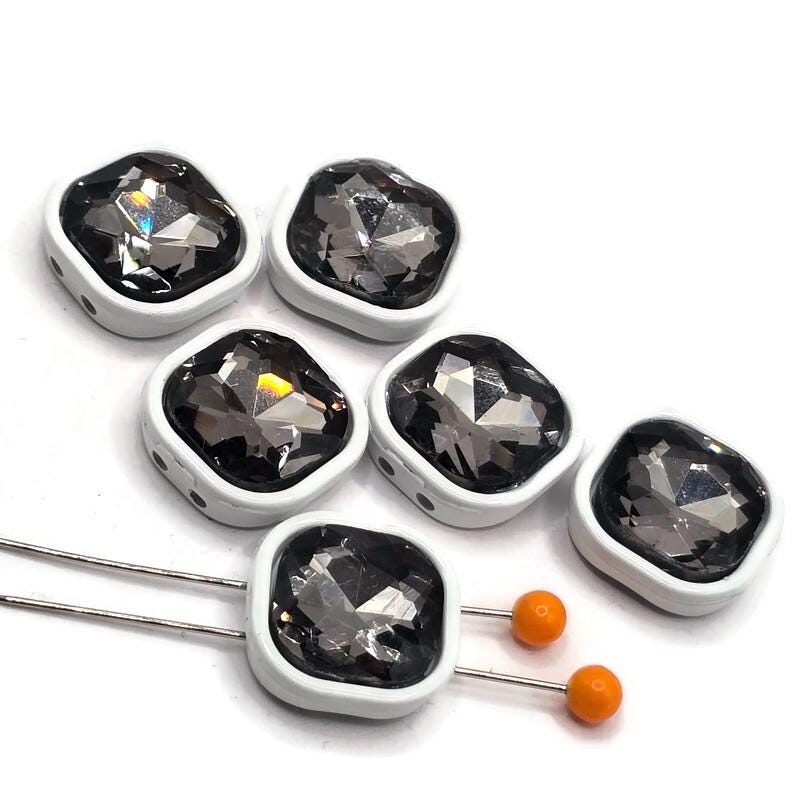 Black diamond rhinestone 2-hole slider beads featuring large faceted stones surrounded by smooth white enamel metal frames. These square jewelry-making beads have two holes on each side to help keep them positioned in bracelet, necklace, and multi-strand designs. The smoky black diamond crystal centers add dramatic sparkle against the crisp white enamel finish. Decorative focal beads for beaded bracelets, handmade jewelry, bead weaving, and DIY jewelry-making projects.