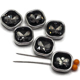 Platinum silver 2 hole slider beads featuring sparkling Black Diamond faceted rhinestone centers for bracelet and jewelry making. The cool silver metal frames have a stainless-steel-colored appearance that contrasts beautifully with the deep smoky crystal centers. Two holes on each side help keep these square focal beads positioned in double-strand and multi-strand designs. Decorative jewelry-making supplies for beaded bracelets, necklaces, bead weaving, handmade jewelry, and jewelry projects.