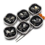 Black Diamond rhinestone 2 hole slider beads in a sleek platinum silver finish that coordinates beautifully with stainless-steel-colored jewelry components. Each square focal bead features a large faceted smoky gray glass rhinestone that reflects shades of charcoal, silver, and black. Two stringing holes on each side make these beads ideal for double-strand bracelets, bead weaving, necklaces, handmade jewelry designs, DIY bracelet making, and creative jewelry making at home.
