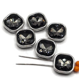 Square Black Diamond rhinestone slider beads set in cool platinum silver metal frames for handmade jewelry designs. These 2 hole focal beads feature large faceted glass stones with smoky charcoal, gray, black, and silver reflections. The stainless-steel-colored finish provides a clean modern look, while two stringing holes on each side make them versatile for double-strand bracelets, bead weaving, necklaces, multi-strand beading, and other creative DIY jewelry-making projects.