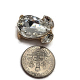 Bright gold rhinestone jewelry connectors with large Clear teardrop crystals and smaller faceted accent stones. These decorative 2 hole slider beads feature hidden loops on the back approximately 9 mm apart for easy incorporation into double-strand jewelry designs. Brilliant crystal sparkle and polished gold make these focal beads ideal for bracelets, bead weaving, wedding jewelry, necklaces, formal accessories, and handmade jewelry projects.