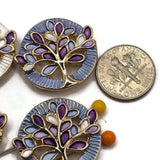 Decorative Tree of Life focal beads featuring intricate bright gold metalwork and colorful enamel leaves in purple, lavender, blue, and white. These beautiful round 2 Hole Slider Beads include coordinating pearly white and soft blue textured backgrounds for versatile jewelry making designs. Perfect for bracelet making, necklace designs, handmade jewelry sets, and nature-inspired accessories. Wonderful jewelry findings for boutique collections, thoughtful gifts, and creative beading projects.