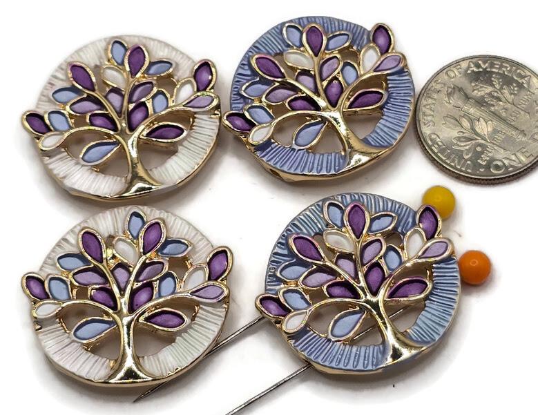 Beautiful Tree of Life 2 Hole Slider Beads featuring colorful purple, lavender, light blue, and white enamel leaves with bright reflective gold branches. These round jewelry focal beads feature complementary pearly white and soft blue circular backgrounds with decorative textured detailing. Perfect for handmade bracelet designs, necklace making, bead weaving, and multi-strand jewelry projects. Unique jewelry making supplies for beginners and experienced jewelry designers creating colorful