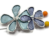 Beautiful silver floral focal beads featuring an elegant combination of dusty blue, slate blue, and soft aqua enamel flowers. Each decorative jewelry component showcases three overlapping five-petal blossoms with bright reflective silver borders and delicate raised centers. These 2 Hole Slider Beads are ideal for handmade jewelry designs, multi-strand bracelets, necklace making, and bead weaving projects. Unique jewelry findings for boutique collections