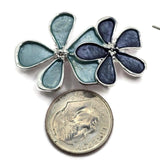 Elegant blue enamel flower jewelry making beads featuring a beautiful cluster of three overlapping blossoms with polished silver outlines. The combination of soft aqua, dusty blue, and darker slate blue petals creates a distinctive floral design. These decorative 2 Hole Slider Beads are ideal for bracelet making, necklace designs, beaded jewelry, and handmade accessories. Unique jewelry findings for creating spring jewelry, floral gifts, and beautiful blue jewelry collections.