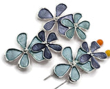 Unique blue enamel flower jewelry making beads featuring three overlapping blossoms in contrasting light aqua and darker slate blue colors. These beautiful floral 2 Hole Slider Beads combine polished silver metalwork, decorative petal outlines, and delicate raised flower centers. Perfect focal beads for handmade bracelets, necklaces, bead weaving, and creative jewelry projects. Wonderful jewelry components for spring designs, garden-inspired accessories,