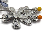Decorative Blue Flower Slider Beads featuring a cluster of three overlapping blossoms in predominantly dark slate blue and smoky denim blue enamel. A contrasting soft aqua flower adds a beautiful lighter accent to the layered floral design. Bright reflective silver outlines and textured flower centers complete these elegant jewelry components. Excellent beading supplies for handmade bracelets, necklace making, floral jewelry designs, and creative accessories featuring rich blue colors.