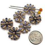 Beautiful gold flower focal beads featuring contrasting dusty blue and deep charcoal blue enamel petals with delicate textured surfaces. Each round floral jewelry component showcases alternating highly reflective gold petals and colorful enamel accents surrounding a raised gold center. These 2 Hole Slider Beads are perfect for handmade jewelry designs, multi-strand bracelets, necklace making, and bead weaving projects.