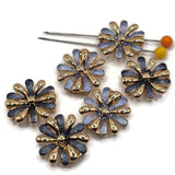Elegant bright gold floral jewelry making beads featuring dimensional daisy-inspired flowers with alternating reflective gold and smoky blue enamel petals. This coordinated package includes lighter dusty blue and deeper charcoal blue flower designs with decorative raised gold centers. These beautiful 2 Hole Slider Beads are ideal for bracelet making, necklace designs, beaded jewelry, and handmade accessories.