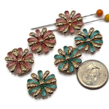 Beautiful gold flower focal beads featuring contrasting dusty rose pink and turquoise teal enamel petals with delicate textured surfaces. Each round floral jewelry component showcases alternating highly reflective gold petals and colorful enamel accents surrounding a raised gold center. These 2 Hole Slider Beads are perfect for handmade jewelry designs, multi-strand bracelets, necklace making, and bead weaving projects.