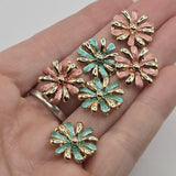 Elegant bright gold floral jewelry making beads featuring dimensional flowers with alternating polished gold and colorful enamel petals. The package includes warm dusty rose pink and rich turquoise teal green flower designs with decorative raised gold centers. These beautiful 2 Hole Slider Beads are ideal for bracelet making, necklace designs, beaded jewelry, and handmade accessories. Unique jewelry findings for creating colorful floral bracelets, bohemian jewelry, and thoughtful handmade gifts.