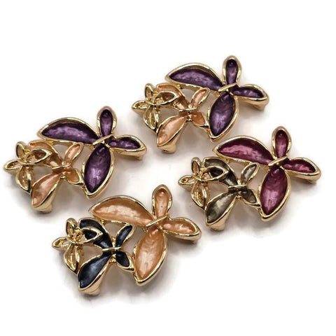Stunning multicolor Flower Slider Beads featuring an artistic arrangement of overlapping enamel blossoms accented with highly polished bright gold metalwork. The coordinating package includes rich purple and champagne flowers, burgundy and smoky neutral combinations, and charcoal blue with warm peach accents. These dimensional floral jewelry focal beads are ideal for handmade bracelets, beaded necklaces, multi-strand jewelry, and creative bead weaving.