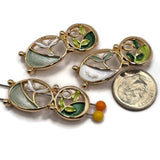 Beautiful bright gold botanical 2 Hole Slider Beads featuring two connected oval shapes with delicate enamel leaves in forest green, mint, pale aqua, lime green, and pearly ivory. Each decorative jewelry focal bead combines graceful gold branches, openwork detailing, and contrasting green enamel sections. These unique jewelry making components are perfect for handmade bracelets, necklace designs, bead weaving, and multi-strand jewelry.