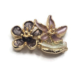 Decorative chocolate brown and dusty mauve 2 Hole Slider Beads featuring beautiful layered flowers with textured enamel petals and polished bright gold metalwork. The overlapping blossoms showcase intricate gold centers, smoky neutral colors, and a delicate pearly ivory leaf beneath the floral arrangement. Excellent jewelry making components for bracelets, necklaces, bead weaving, and handmade accessories.