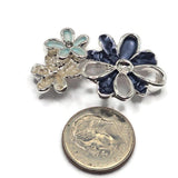 Decorative navy blue and light aqua 2 Hole Slider Beads featuring beautiful layered flowers with textured enamel petals and reflective bright silver outlines. The floral arrangement combines contrasting shades of blue with delicate pearly ivory blossoms and raised metallic flower centers. Excellent jewelry making components for bracelets, necklaces, bead weaving, and handmade accessories.