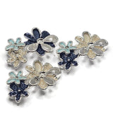 Unique cream and blue enamel flower jewelry-making beads featuring layered floral clusters with pearly ivory, deep navy, and soft aqua blossoms. These decorative 2 Hole Slider Beads combine textured enamel petals, highly reflective bright silver metalwork, and dimensional overlapping flower designs. Perfect focal beads for handmade bracelets, necklaces, bead weaving, and coordinated jewelry sets.