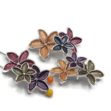 Elegant peach, burgundy, and charcoal gray flower jewelry-making bead featuring three dimensional blossoms arranged in an overlapping floral cluster. The warm peach flower contrasts beautifully with rich wine-colored burgundy and smoky dark gray enamel petals. Highly reflective bright silver outlines define each flower and enhance the textured details.