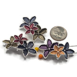 Unique floral 2 Hole Slider Beads showcasing rich coordinating enamel colors with polished bright silver outlines. The decorative three-flower clusters feature combinations of deep navy blue, wine burgundy, warm peach, violet purple, and smoky olive gray blossoms. Textured five-petal flowers create beautiful dimension and contrast. These colorful focal beads are perfect for handmade bracelets, necklaces, bead weaving, and multi-strand jewelry.