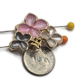 Close-up of pink, gray, and pearl white enamel floral slider beads in a polished bright gold finish. Each decorative focal bead features a large soft pink flower with delicately textured petals, accompanied by two smaller flowers in smoky charcoal-gray and luminous pearl white enamel. Gold outlines and tiny raised centers add beautiful dimensional detail. Ideal for double-strand bracelets, necklaces, bead weaving, and handmade botanical accessories.
