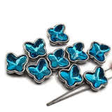 Small electric blue butterfly slider beads in polished platinum silver settings, measuring approximately 11 mm wide and 10.5 mm tall with 5 mm between the holes. Each decorative bead features a vibrant faceted blue butterfly-shaped stone with brilliant turquoise and deep blue reflections. Compact 2 hole jewelry-making focal beads for bead weaving, double-strand bracelets, necklaces, and decorative cuffs.