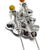 Detailed view of bright silver floral 2 hole slider beads featuring contrasting black, charcoal-gray, and pearl white enamel flowers. The larger black flower has softly textured petals, while the smaller flowers display smoky metallic gray and luminous pearlescent white finishes. Polished silver outlines and raised floral centers create a beautiful monochromatic jewelry-making focal bead.