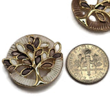 Stunning round Tree of Life Slider Beads featuring bright reflective gold branches surrounded by beautiful brown, topaz, and ivory enamel leaves. These decorative jewelry focal beads feature complementary earthy brown and pearly ivory circular backgrounds with intricate textured borders. Perfect for creating handmade bracelets, beaded necklaces, multi-strand jewelry, and creative bead weaving projects. Beautiful jewelry components for designers who enjoy the colors, symbols, and gold accents.