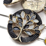 Decorative Tree of Life focal beads featuring intricate bright gold metalwork and earthy enamel leaves in chocolate brown, taupe, beige, and ivory colors. These beautiful round 2 Hole Slider Beads include coordinating dark brown and pearly ivory textured backgrounds for versatile jewelry making designs. Perfect for bracelet making, necklace designs, handmade jewelry sets, and nature-inspired accessories.