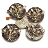 Stunning round Tree of Life Slider Beads featuring bright reflective gold branches surrounded by beautiful smoky gray, dark charcoal, and ivory enamel leaves. These decorative jewelry components include coordinating dark gray and pearly ivory circular backgrounds with detailed textured borders. Wonderful focal beads for handmade bracelets, beaded necklaces, multi-strand jewelry, and creative bead weaving. Versatile jewelry making supplies for designers
