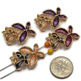 Unique multicolor enamel flower jewelry making beads featuring layered floral clusters with rich purple, burgundy, charcoal blue, champagne, and warm peach petals. These decorative 2 Hole Slider Beads combine dimensional flowers, textured enamel surfaces, and highly reflective bright gold metalwork. Ideal focal beads for handmade bracelets, necklaces, earrings, bead weaving, and creative jewelry projects.