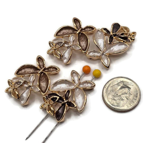 Beautiful champagne brown and ivory floral 2 Hole Slider Beads featuring three overlapping flowers with softly textured neutral enamel petals and highly reflective bright gold outlines. The coordinated package includes warm champagne brown, pearly ivory white, and deep chocolate brown flower combinations with delicate openwork gold accents. Perfect jewelry making supplies for handmade bracelets, necklace designs, bead weaving, and multi-strand jewelry.