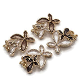 Stunning neutral color Flower Slider Beads featuring an artistic arrangement of overlapping enamel blossoms accented with highly polished bright gold metalwork. The coordinated package includes champagne brown flowers paired with pearly ivory accents and ivory white flowers complemented by deep chocolate brown blossoms. These dimensional floral jewelry focal beads are ideal for handmade bracelets, beaded necklaces, multi-strand jewelry, and creative bead weaving.