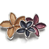 Unique bright silver floral slider bead featuring an elegant arrangement of three overlapping enamel flowers in soft golden peach, rich burgundy, and dark charcoal gray. The elongated flower petals feature delicate textured detailing and polished metallic outlines that create contrast and dimension. These decorative 2 Hole Slider