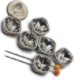 Detailed view of platinum silver square rhinestone slider beads showcasing beautiful transparent clear stones with multiple reflective facets. Each cushion-cut rhinestone features softly rounded corners and a smooth polished silver frame. Brilliant flashes of white, silver, and subtle iridescent reflections create an eye-catching sparkling appearance.