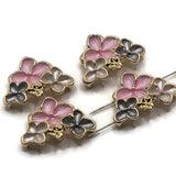 Four bright gold floral 2 hole slider beads featuring layered flowers in soft pink, smoky gray, and pearlescent white enamel. Each decorative bead measures approximately 30 mm wide and 23 mm tall, with 11 mm between the holes. The dimensional floral arrangement features polished gold outlines, textured petals, and tiny raised gold centers. Beautiful jewelry-making components for handmade bracelets, necklaces, bead weaving, and coordinated jewelry sets.