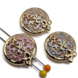 Three bright gold round floral filigree 2 hole slider beads featuring intricate openwork patterns and dimensional gold flower accents. Each decorative bead showcases softly textured pastel enamel in blush pink, pearl white, or silvery gray. The polished gold circular frames and raised floral embellishments create an elegant vintage-inspired appearance. Beautiful jewelry-making components for handmade bracelets, necklaces, bead weaving, and botanical jewelry designs.