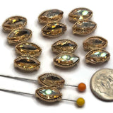 Six bright gold champagne rhinestone 2 hole slider beads featuring two sparkling marquise-shaped stones arranged in a vertical double-stone design. Each decorative bead showcases warm champagne-colored faceted rhinestones surrounded by textured gold settings. The polished bright gold finish complements the golden tones of the stones, creating elegant jewelry-making components for handmade bracelets, necklaces, bead weaving, and sparkling accessories.
