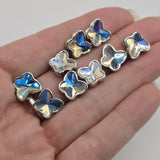 Sparkling Clear AB butterfly 2 hole slider beads featuring faceted Aurora Borealis stones and polished platinum silver settings. The clear stones reflect beautiful rainbow highlights, creating a versatile decorative butterfly design. Nine butterfly focal beads per package for handmade bracelets, necklaces, bridal-inspired jewelry, butterfly accessories, bead-woven cuffs, and creative jewelry-making projects.